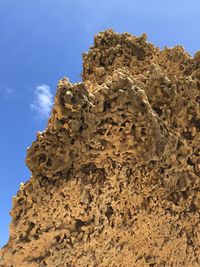 Low angle view of rock formation against sky