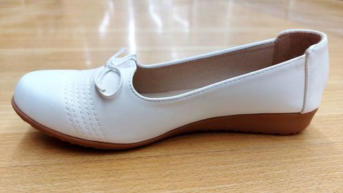 Close-up of shoes on wooden table