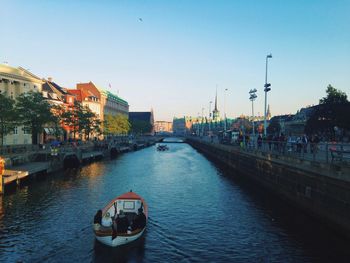 Boats in river with buildings in background