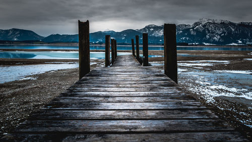 Pier over lake against sky