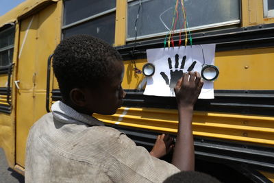 Rear view portrait of boy in bus