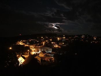 High angle view of illuminated buildings in city at night