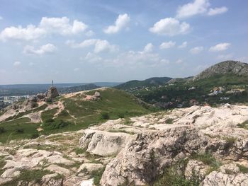 Scenic view of rocky mountains and sea against sky