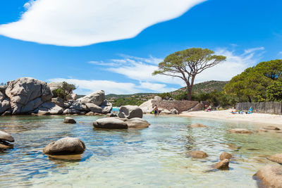 Scenic view of rocks in sea against sky