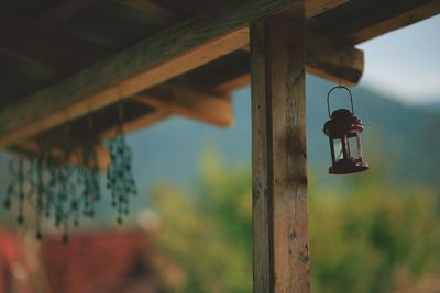 Close-up of lamp hanging on porch