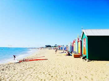 View of beach against clear blue sky