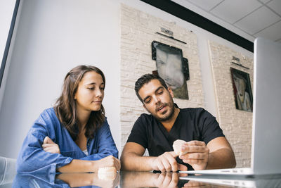 Young couple sitting on table