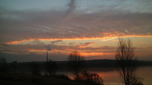 Scenic view of lake against sky during sunset