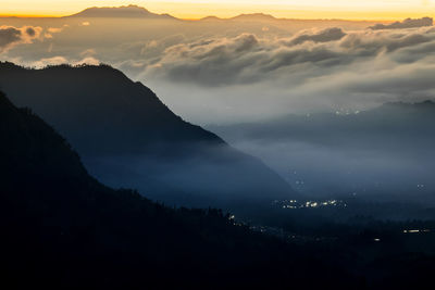 Scenic view of silhouette mountains against sky during sunset