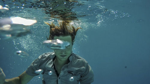 Young man swimming in pool