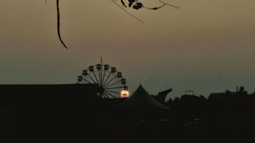 Silhouette of birds flying against sky at sunset