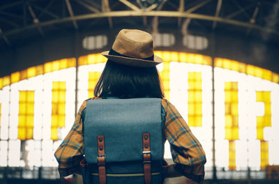 Rear view of woman standing at airport