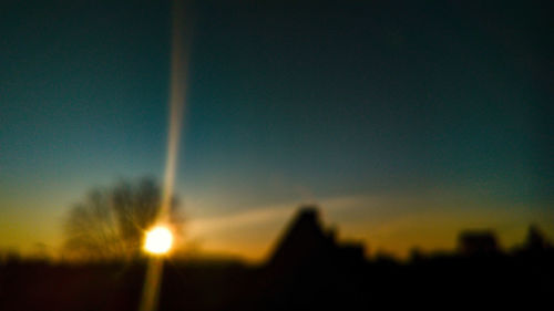 Close-up of illuminated building against sunset sky