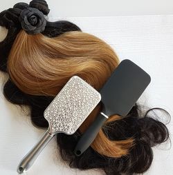 Directly above shot of wig and hairbrushes on table