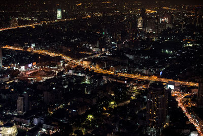 High angle view of illuminated city buildings at night