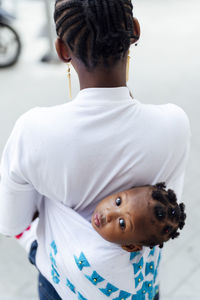 Rear view of boy with dog