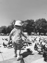 Rear view of boy standing on field