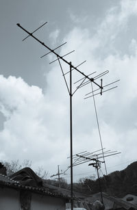 Low angle view of telephone pole against sky