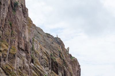 Low angle view of rocky mountains against sky