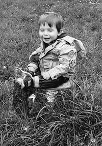 Portrait of boy smiling on field