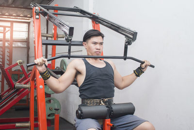 Man exercising on machinery in gym