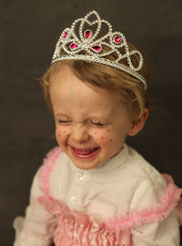 Close-up of happy girl wearing crown