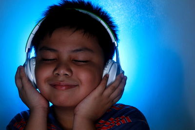 Portrait of boy against blue background