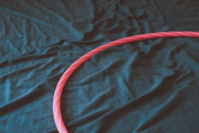 High angle view of pink pipe on textile