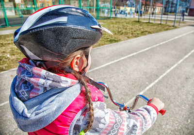 Girl riding bicycle on road