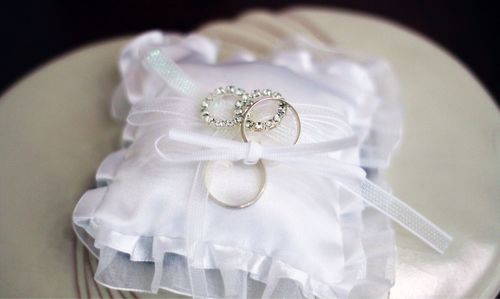High angle view of wedding rings on white fabric