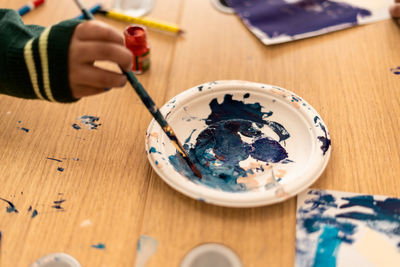 High angle view of hand painting on table