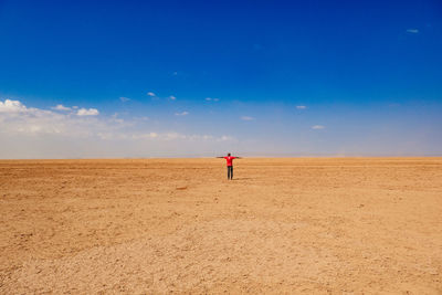Rear view of a man standing in the desert at chalbi desert in marsabit county, kenya