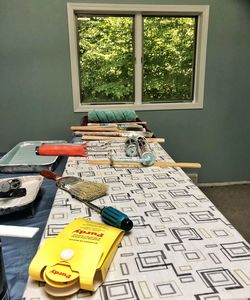 Close-up of open book on table by window