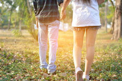 Low section of couple standing outdoors