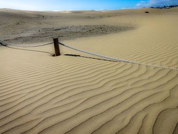 Scenic view of sand dune in desert against sky