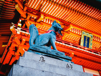 Low angle view of statue against temple