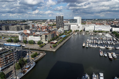 High angle view of river amidst buildings in city against sky