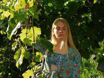 Woman standing against plants