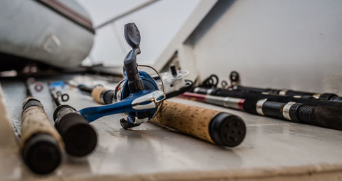 Close-up of various fishing rods on table