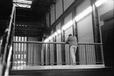 Full length of woman standing on railing