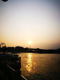 Scenic view of river against sky during sunset