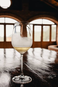 A glass of white wine on rustic wooden table close-up. wine tasting