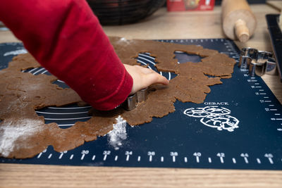 Cropped hands of person preparing food on table