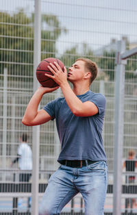 Young man playing basketball in court