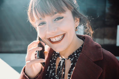 Portrait of smiling woman talking on phone