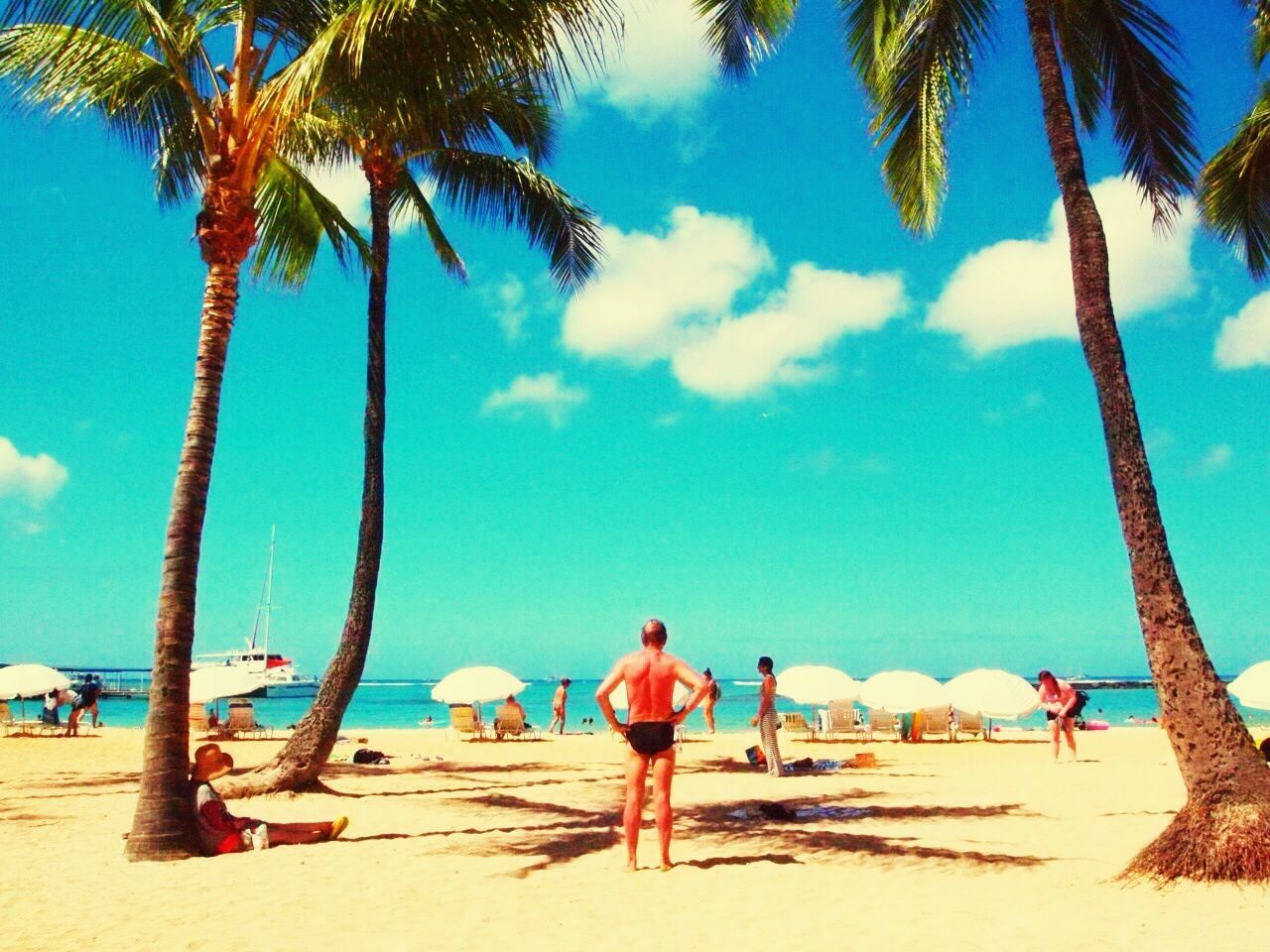 beach, sand, leisure activity, sky, palm tree, tree, lifestyles, vacations, person, blue, men, full length, shore, tourist, sea, beach umbrella, nature, sunlight, walking