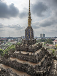 Temple against buildings in city