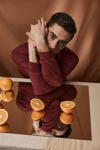 Portrait of man sitting on table