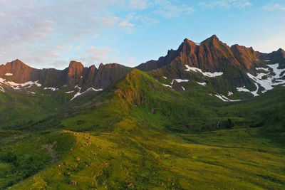 Mountain peaks with snow during sunset in senja island, norway