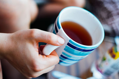 Close-up of woman holding tea cup